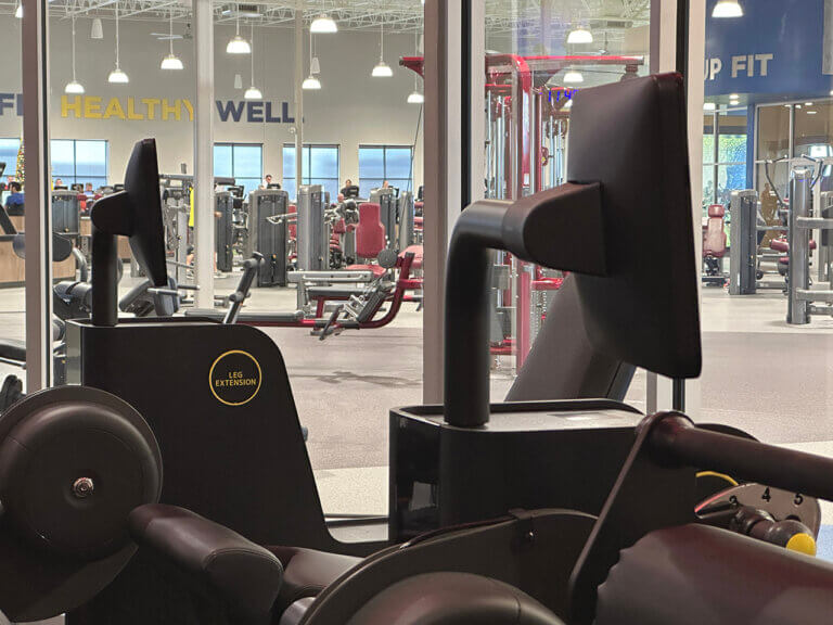 Modern gym with leg extension machine.