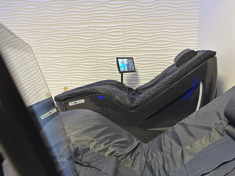 Modern massage chair in relaxing room setting.