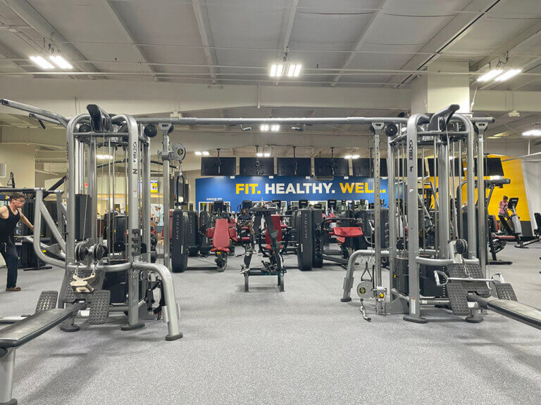 Spacious gym with workout equipment.