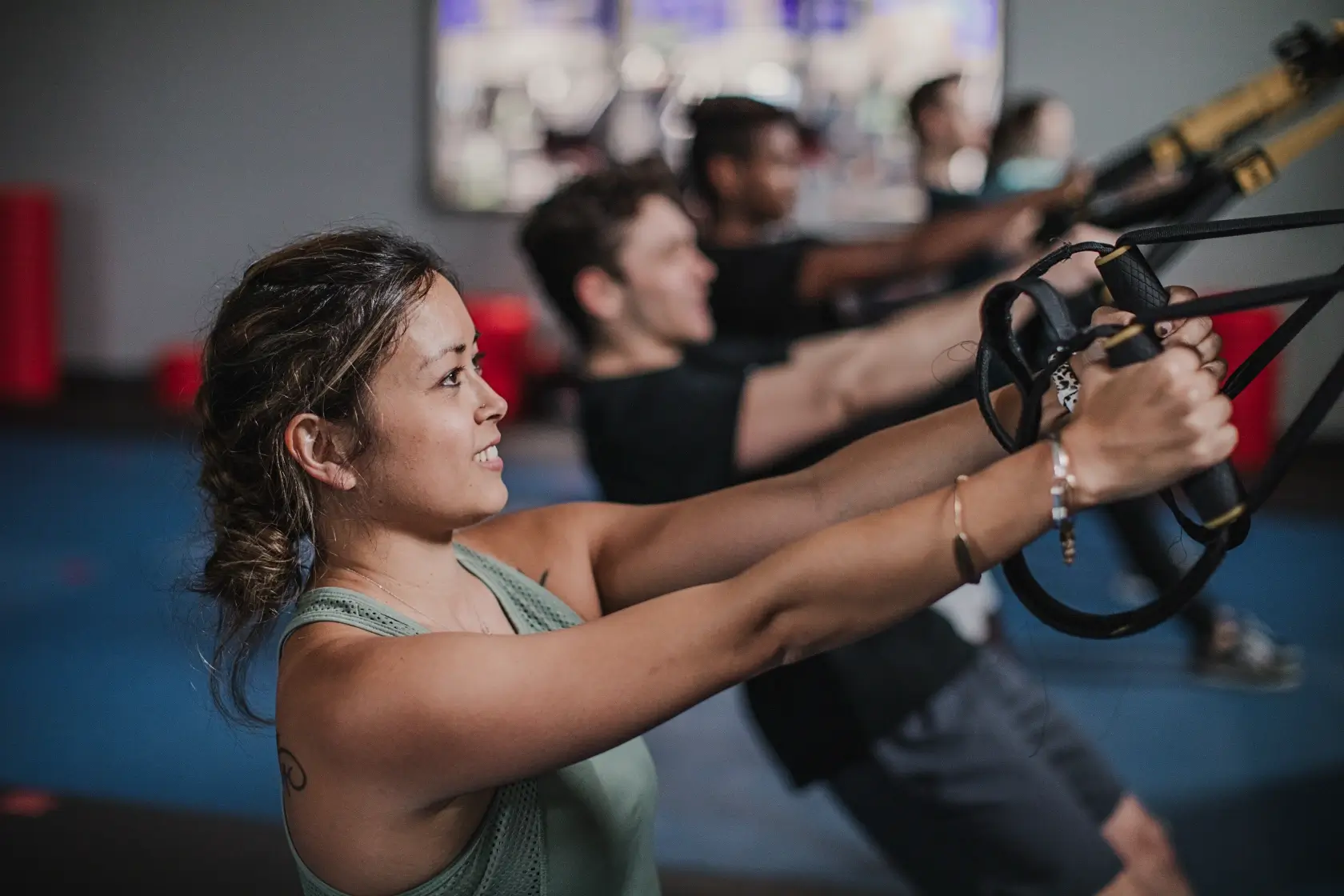 Group workout using resistance bands in gym.