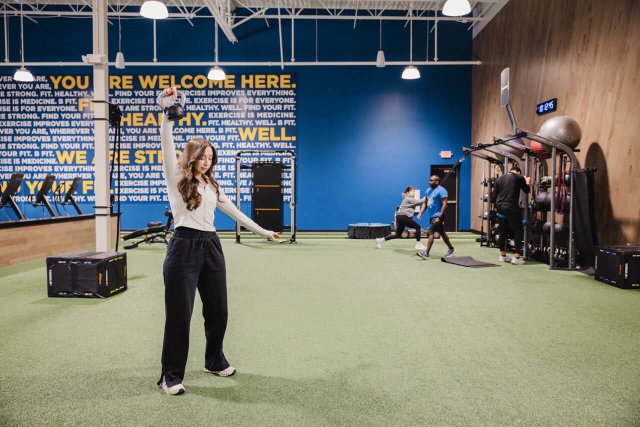 People exercising in a gym with turf flooring