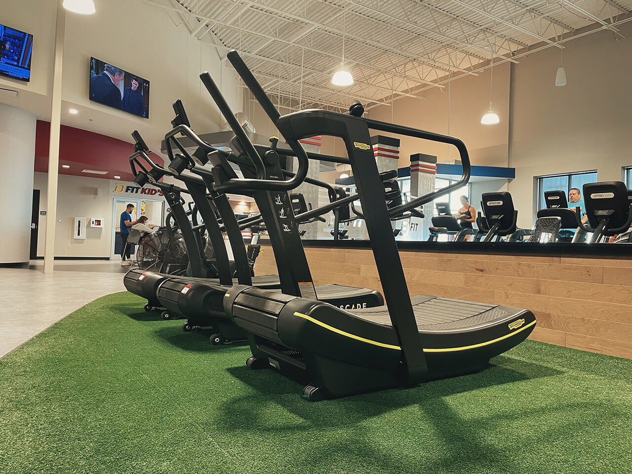Curved treadmills on turf in modern gym
